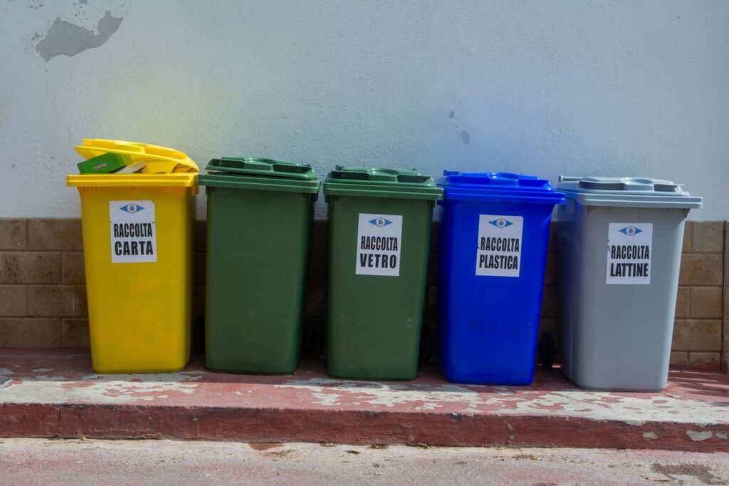 Circular Economy in Action: How Corporations Are Turning Waste into Value Five colorful recycling bins organized for waste segregation in an urban setting.