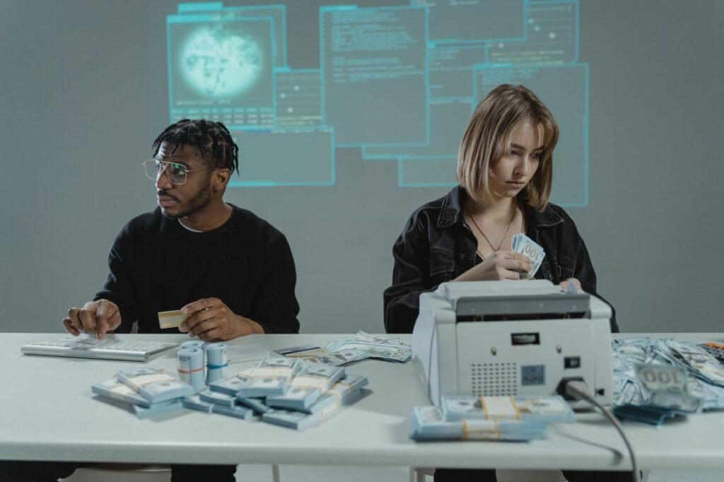 Cybersecurity as a Growth Industry: Why Trust Is the New Currency Two individuals counting US dollar bills with a money machine, highlighting finance themes.