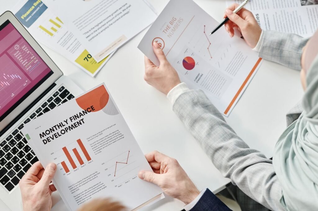 ESG Reporting: From Compliance to Competitive Advantage Top view of business colleagues analyzing financial reports during a meeting at the office.